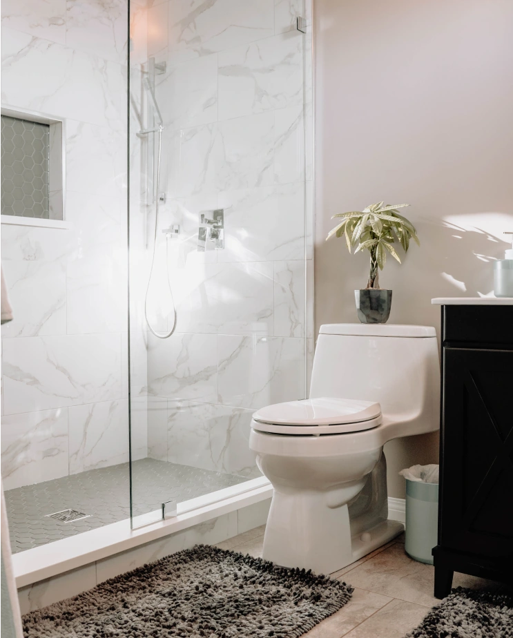 Modern, white bathroom with marble shower walls, installed by Granite Gomez.